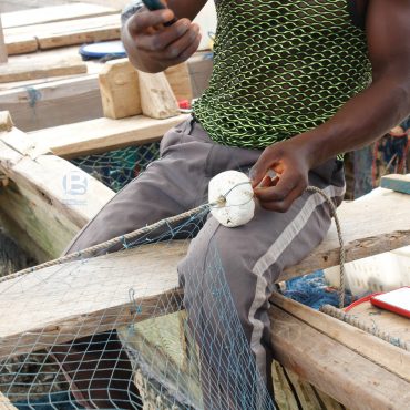 Fisherman mending net